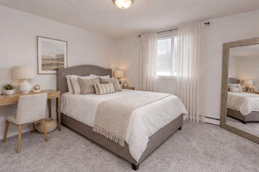 Bedroom with neutral decor and large mirror at Prosper West Apartments, Waite Park