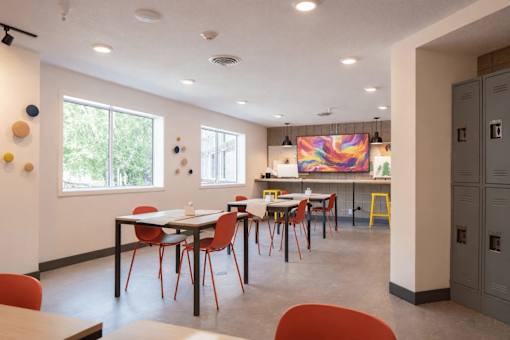 Community lounge with seating and colorful artwork at Regency Park Apartments, St Cloud, 56304