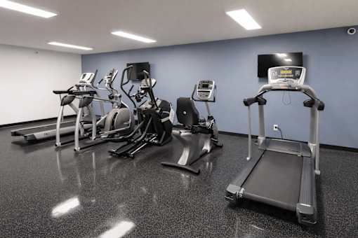 Fitness center with cardio and strength equipment at Regency Park Apartments, St Cloud