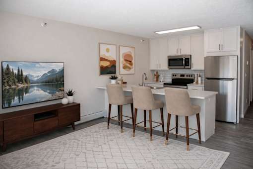 Open concept living area with kitchen island and bar seating at Regency Park Apartments, St Cloud, MN