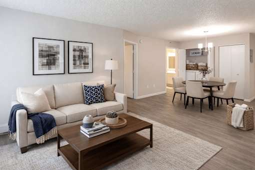 Open concept living and dining area with wood style flooring at Regency Park Apartments, St Cloud, Minnesota