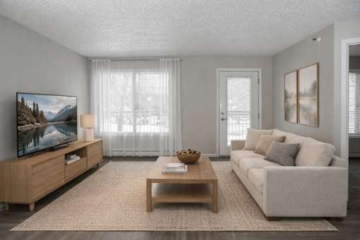 Living room with modern furniture and patio door at Regency Park Apartments, St Cloud