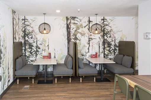 Private dining booths with forest mural wallpaper at Regency Park Apartments, St Cloud, MN
