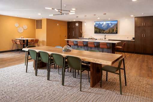 Community room with dining tables and kitchen bar at Regency Park Apartments, St Cloud, 56304