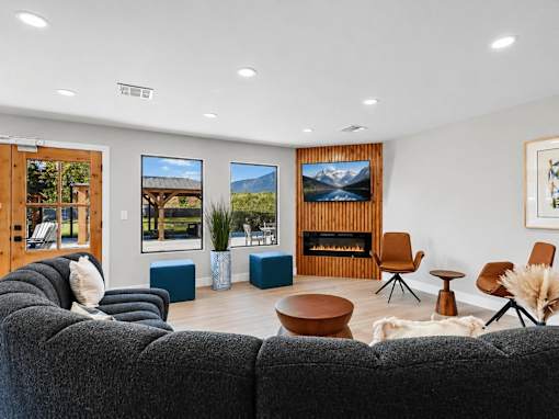 Modern clubhouse lounge with fireplace and seating at Lexington Park Apartments, Utah, 84119