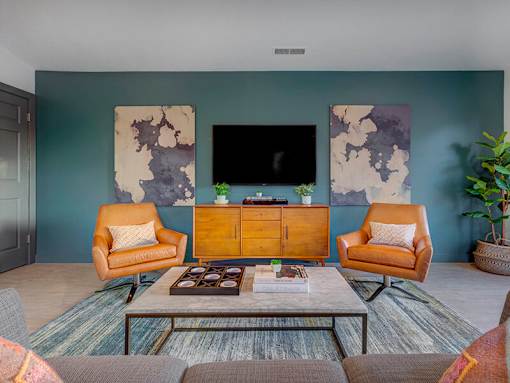 Modern living room with blue accent wall at Creekview Apartments, Midvale, UT 84047