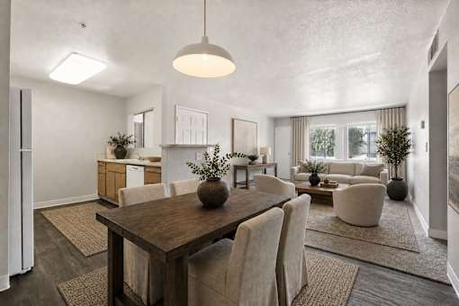 A modern dining room with a wooden table and chairs.