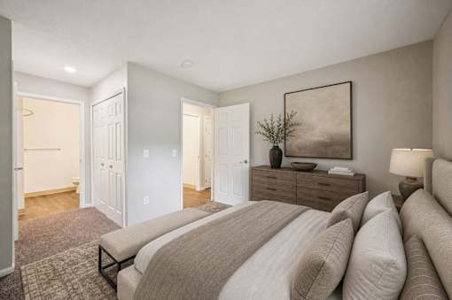 Master bedroom with ensuite bathroom and neutral tones at Northview Park Apartments, Sterling Heights