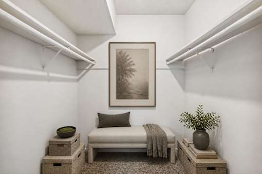 Walk-in closet with bench and shelving at Stratford Arms Apartments, Riverdale, 30274