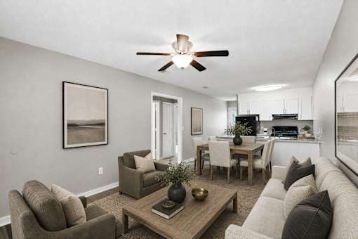 A living room with a couch, chairs, and a coffee table.