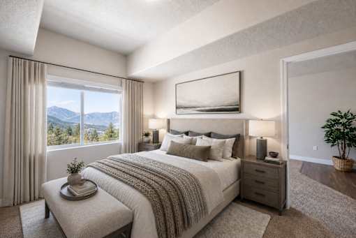 Master bedroom with mountain views and neutral decor at The Ellison Apartments, Layton, Utah
