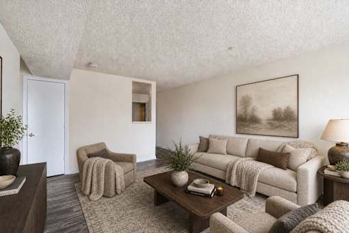 A living room with a couch, chair, and coffee table.