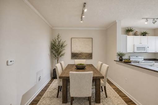A dining room with a wooden table and chairs.