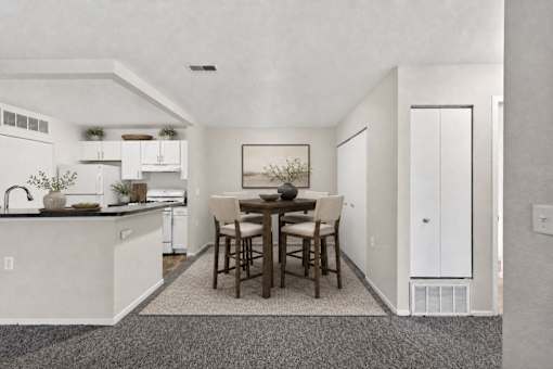 A kitchen with a dining table and chairs.