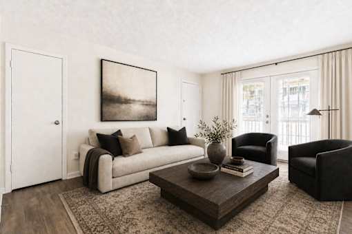 A living room with a couch, chair, and coffee table.