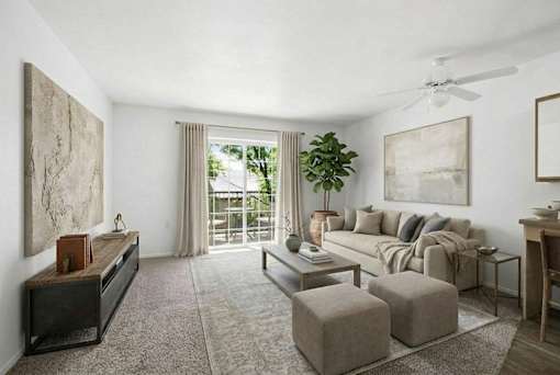A living room with a grey sofa, a wooden coffee table, and a large painting on the wall.