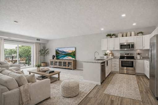 Open concept living room and kitchen with balcony at The Hendrickson Apartments, Minnesota