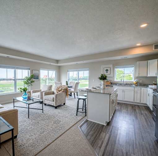Open concept living area with kitchen island at The Hendrickson Apartments, Falcon Heights, MN 55113