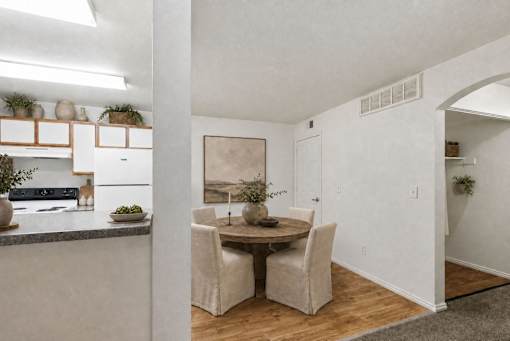 A dining area with a table and chairs.