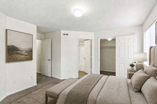 A bedroom with a large bed and a painting on the wall at Slate Canyon Apartments, Provo, UT, 84606