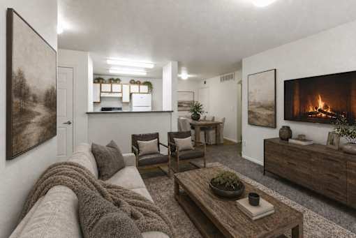 A living room with a grey couch and a fireplace at Slate Canyon Apartments, Provo, Utah