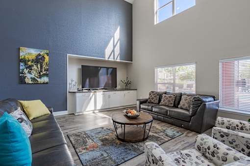 A living room with a grey couch and a coffee table.