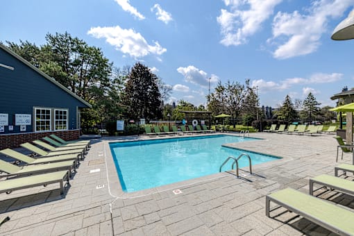 A large outdoor swimming pool surrounded by sun loungers.