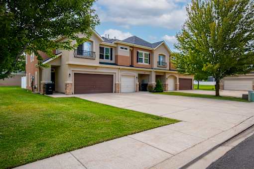 Two-story townhomes with a garage and a driveway.