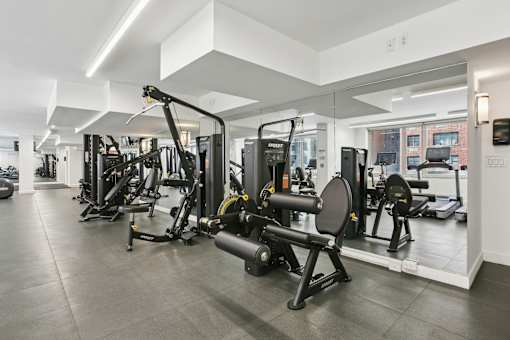 A gym with a variety of equipment including a leg press machine.