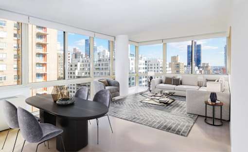 A modern living room with a large table and chairs.
