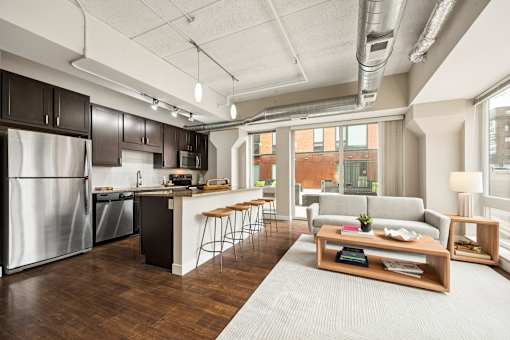 A modern kitchen with dark wood cabinets and stainless steel appliances.
