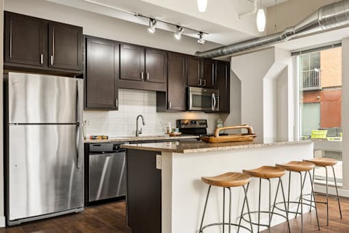 A kitchen with a white refrigerator and a white dishwasher.