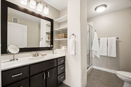 A bathroom with a white sink and a mirror above it.