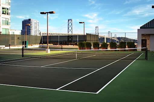 A tennis court with a green surface and white lines.