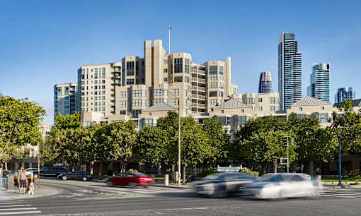 A city street with cars and buildings in the background.