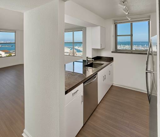A kitchen with a view of the ocean.