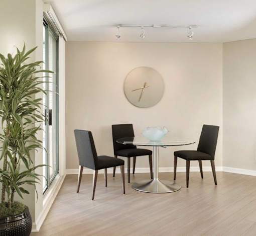 A dining room with a glass table and chairs.