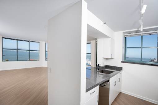 A kitchen with a large island and a view of the water.