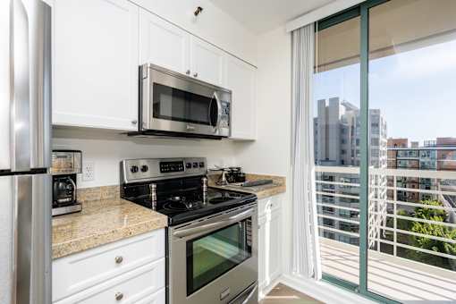 A kitchen with white cabinets and stainless steel appliances.