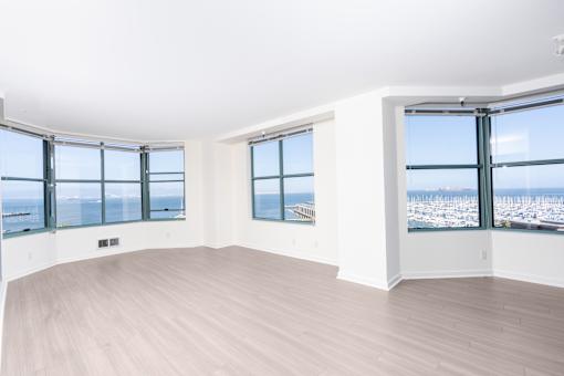 A room with a large window overlooking a cityscape.
