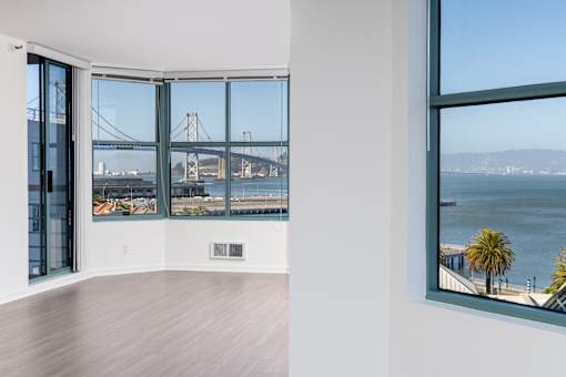 A room with a view of a bridge over the water.