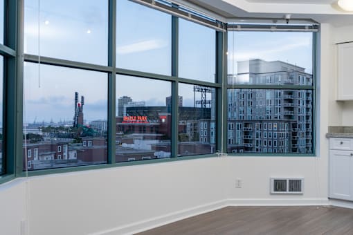 A room with a large window overlooking a cityscape.