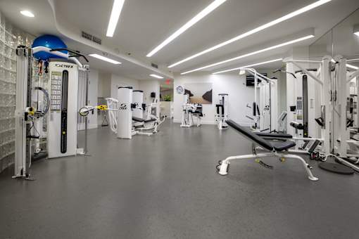 A gym with a variety of equipment including a leg press machine.