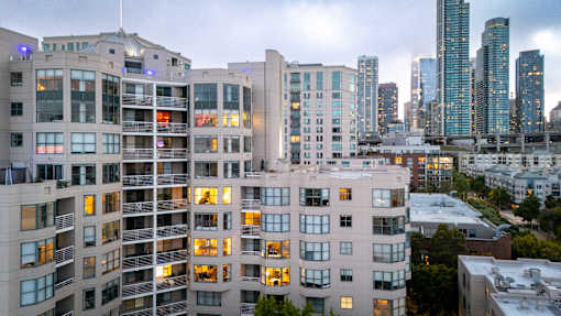 A cityscape with apartment buildings in the foreground and skyscrapers in the background.