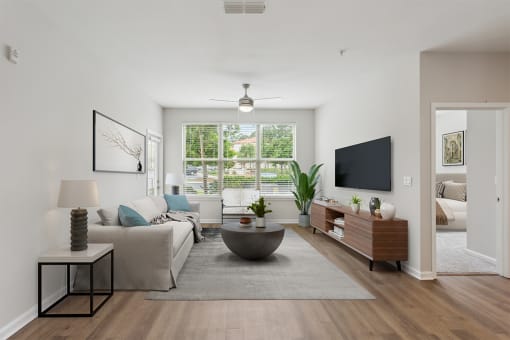 a living room with white walls and a large window at Two Addison Place Apartments , Georgia