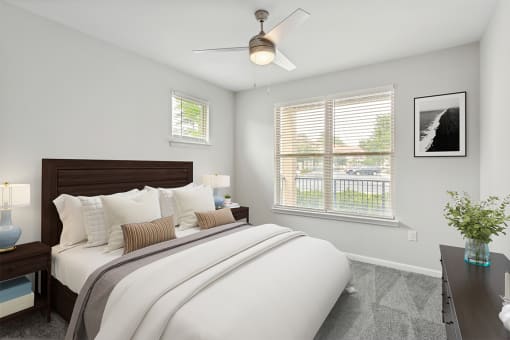 a bedroom with a large bed and two windows at Two Addison Place Apartments , Georgia