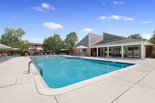 Swimming pool with lounge chairs on pool deck at Westwinds Apartments, Annapolis MD