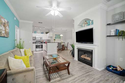 living room with sofa, coffee table and fireplace at The Grand Reserve at Tampa Palms Apartments, Tampa