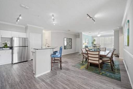 A kitchen with a dining table and chairs at The Grand Reserve at Tampa Palms Apartments, Tampa