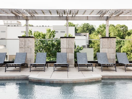 Sundeck with chaise lounge seating and pool at St. Marys Square Apartments, Raleigh